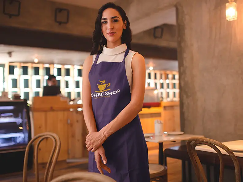 A woman with a coffee shop apron